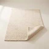 Rectangular wool loop-pile rug in warm ivory