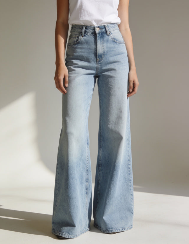 Woman wearing high-rise wide-leg light-wash jeans